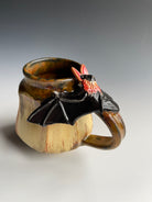 Pottery mug with bat